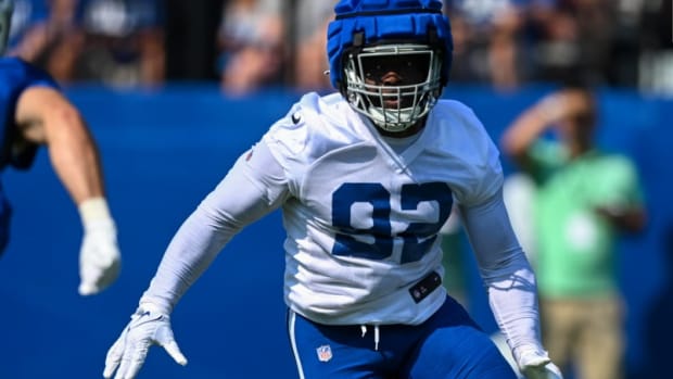 Colts defensive end Genard Avery (white jersey with blue numbers) tries to excel at his training camp defensive drill. 