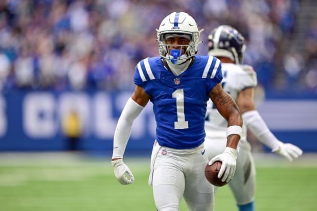 Football player Josh Downs reacts after making a catch in a blue jersey.