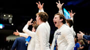 The Xavier Musketeers bench celebrates as they tie th game in the second half of the NCAA Tournament First Four game between the Xavier Musketeers and the Texas Longhorns at University of Dayton Arena in Dayton, Ohio, on Wednesday, March 19, 2025. Xavier advances with an 86-80 win over Texas, moving on to play Illinois in the first round.