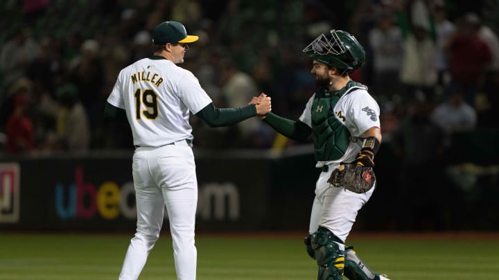 Jun 21, 2024; Oakland, California, USA; Oakland Athletics pitcher Mason Miller (19) celebrates with catcher Shea Langeliers (23) after defeating the Minnesota Twins at Oakland-Alameda County Coliseum. Mandatory Credit: Stan Szeto-USA TODAY Sports