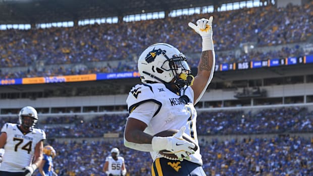 West Virginia Mountaineers running back Jahiem White (1) celebrates after scoring a touchdown against the Pittsburgh Panthers