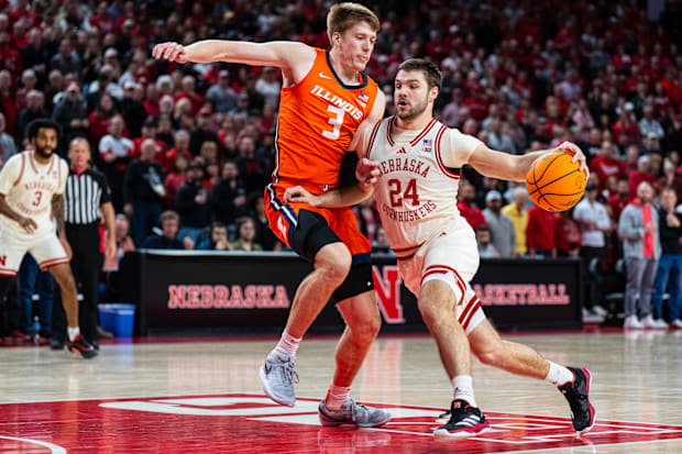 Nebraska Cornhuskers guard Rollie Worster (24) drives against Illinois Fighting Illini forward Ben Humrichous (3).