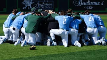 The Tulane Green Wave baseball program gathers in prayer moments before it takes the diamond