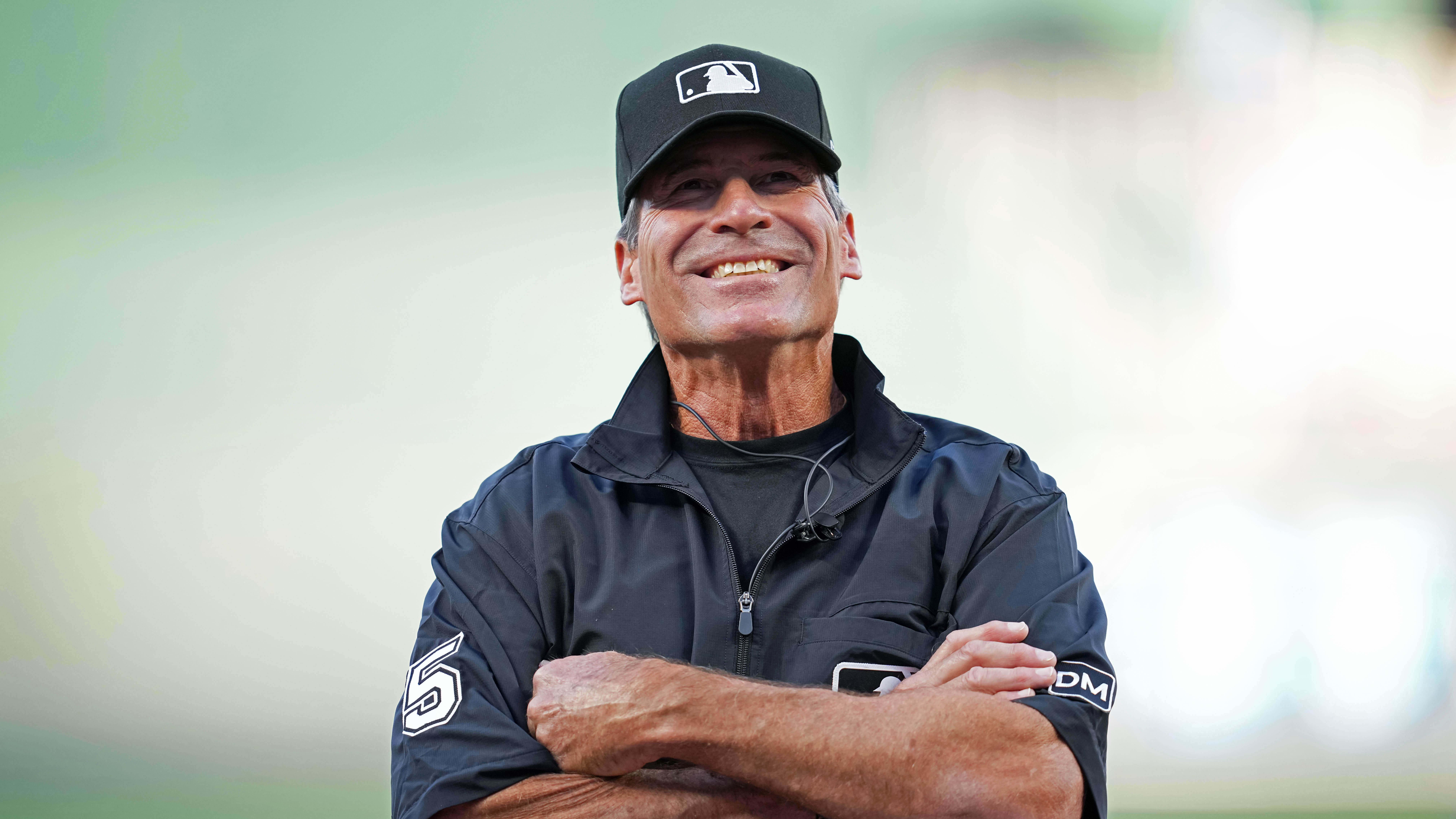 Aug 15, 2023; Kansas City, Missouri, USA; Umpire Angel Hernandez (5) smiles prior to a game between the Royals and Mariners.