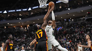 Mar 30, 2025; Milwaukee, Wisconsin, USA;  Milwaukee Bucks forward Giannis Antetokounmpo (34) shoots against Atlanta Hawks center Onyeka Okongwu (17) during the first quarter at Fiserv Forum. Mandatory Credit: Jeff Hanisch-Imagn Images