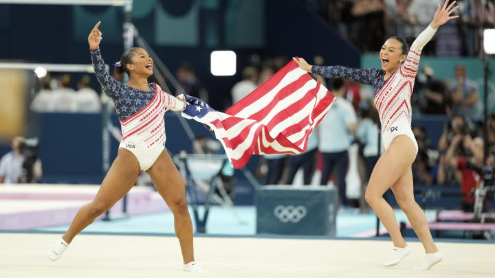 Jul 30, 2024; Paris, France; Jordan Chiles and Sunisa Lee of the United States celebrate after winning gold in the women’s team final at the Paris 2024 Olympic Summer Games at Bercy Arena. 