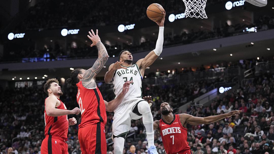 Nov 9, 2025; Milwaukee, Wisconsin, USA; Milwaukee Bucks forward Giannis Antetokounmpo (34) drives to the basket against Houston Rockets center Steven Adams (12) and Houston Rockets forward Kevin Durant (7) in the second half at Fiserv Forum. Mandatory Credit: Michael McLoone-Imagn Images