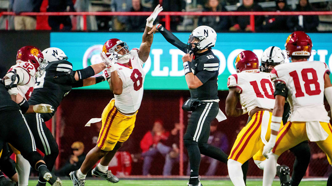 Nov 1, 2025; Lincoln, Nebraska, USA; Nebraska Cornhuskers quarterback Dylan Raiola (15) passes against Southern California Trojans defensive tackle Devan Thompkins (8) during the second quarter at Memorial Stadium. Mandatory Credit: Dylan Widger-Imagn Images