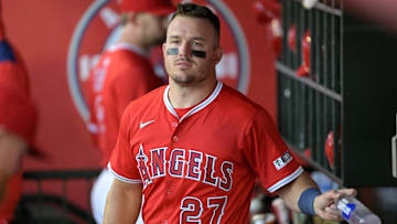 Mar 24, 2025; Anaheim, California, USA;  Los Angeles Angels center fielder Mike Trout (27) looks on from the dugout against the Los Angeles Dodgers at Angel Stadium. 