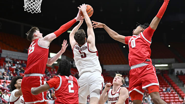 Oct 25, 2025; Pullman, WA, USA; Washington State Cougars guard Tomas Thrastarson (5) rebounds the ball against New Mexico Lobos center JT Rock (35) and guard Kevin Patton Jr. (0) in the first half at Friel Court at Beasley Coliseum. Mandatory Credit: James Snook-Imagn Images