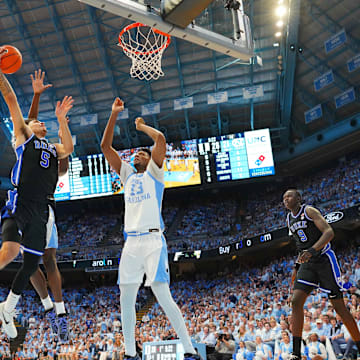 Mar 8, 2025; Chapel Hill, North Carolina, USA;  Duke Blue Devils guard Tyrese Proctor (5) shoots as North Carolina Tar Heels forward Jalen Washington (13) defends in the first half at Dean E. Smith Center. 