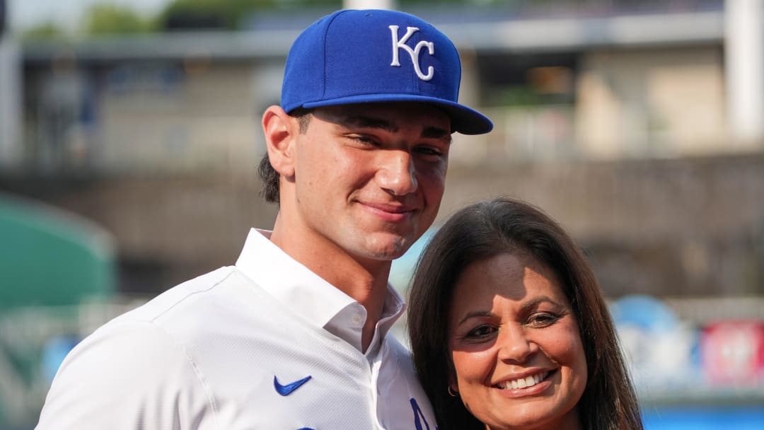 Jul 24, 2024; Kansas City, Missouri, USA; Kansas City Royals first round draft pick Jac Caglianone poses with his mother Johanne Caglianone for photos on the field prior to a game against the Arizona Diamondbacks at Kauffman Stadium. Mandatory Credit: Denny Medley-USA TODAY Sports