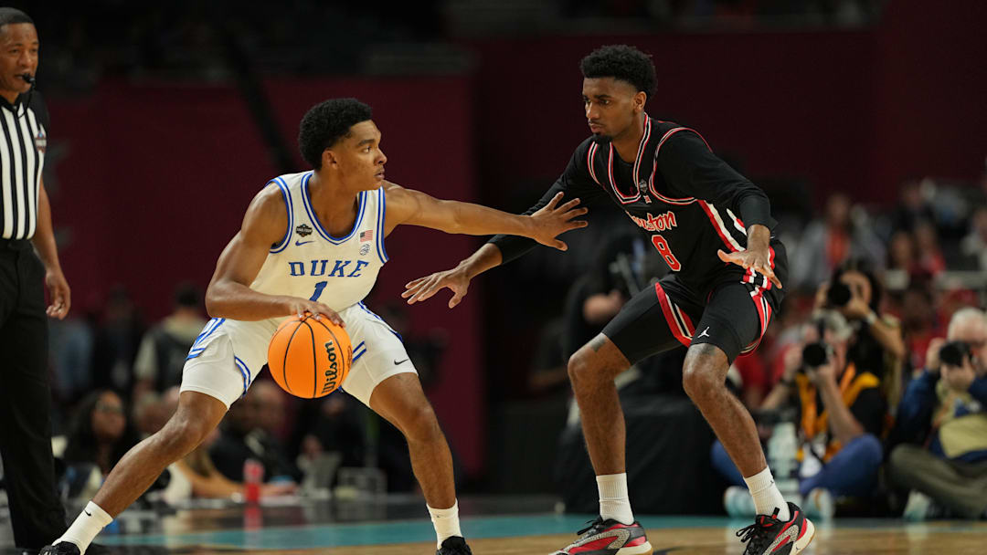 Apr 5, 2025; San Antonio, TX, USA; Duke basketball guard Caleb Foster (1) dribbles the ball against Houston Cougars guard Mylik Wilson (8) during the first half in the semifinals of the men's Final Four of the 2025 NCAA Tournament at the Alamodome.