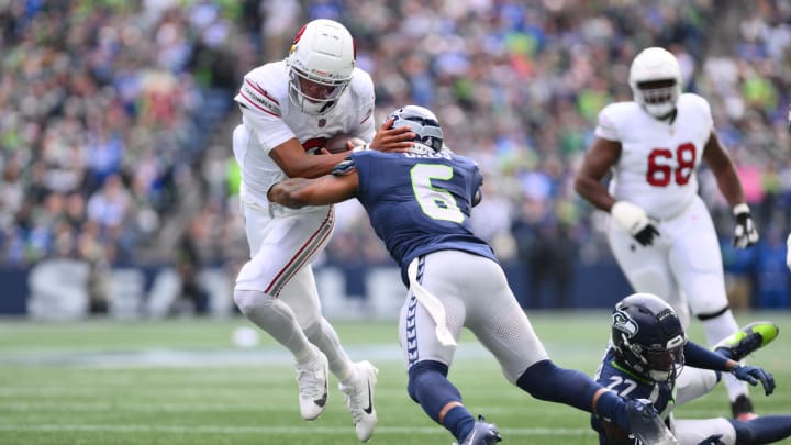 Oct 22, 2023; Seattle, WA; Arizona Cardinals quarterback Joshua Dobbs (9) breaks a tackle attempt by Seattle Seahawks safety Quandre Diggs (6) to later run the ball in for a touchdown during the first half at Lumen Field. 