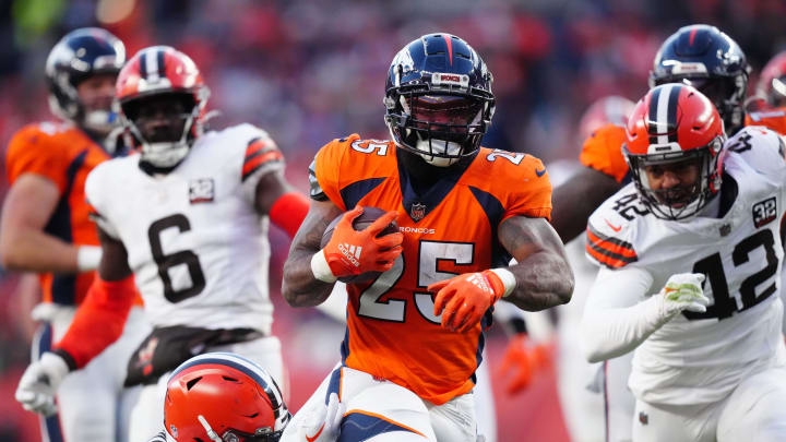 Nov 26, 2023; Denver, Colorado, USA; Denver Broncos running back Samaje Perine (25) carries the ball in the first half at Empower Field at Mile High. Mandatory Credit: Ron Chenoy-USA TODAY Sports