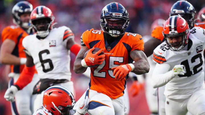 Nov 26, 2023; Denver, Colorado, USA; Denver Broncos running back Samaje Perine (25) carries the ball in the first half at Empower Field at Mile High. Mandatory Credit: Ron Chenoy-USA TODAY Sports