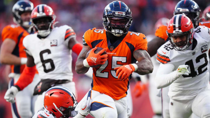 Nov 26, 2023; Denver, Colorado, USA; Denver Broncos running back Samaje Perine (25) carries the ball in the first half at Empower Field at Mile High. Mandatory Credit: Ron Chenoy-USA TODAY Sports