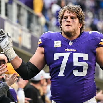 Dec 1, 2024; Minneapolis, Minnesota, USA; Minnesota Vikings offensive tackle Brian O'Neill (75) reacts with the crowd after the game against the Arizona Cardinals at U.S. Bank Stadium.