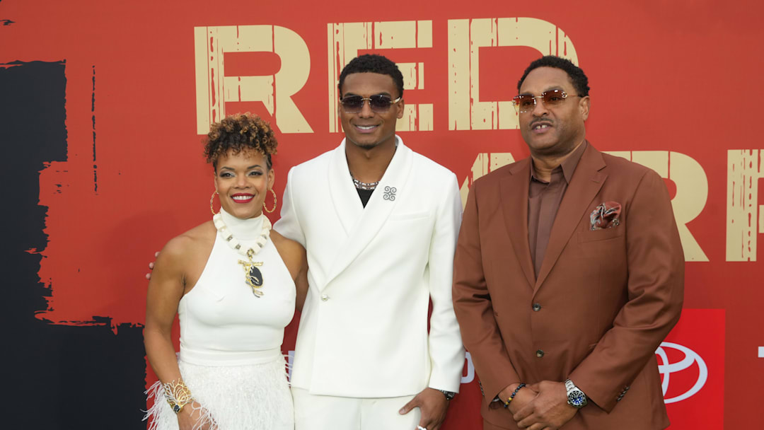 Apr 24, 2025; Green Bay, WI, USA; Michigan Wolverines cornerback Will Johnson with his parents Kafi Kumasi and Deon Johnson on the red carpet before the 2025 NFL Draft at Lambeau Field. Mandatory Credit: Kirby Lee-Imagn Images
