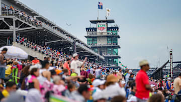 Racing fans pack the viewing mounds during the Indianapolis 500 at Indianapolis Motor Speedway.