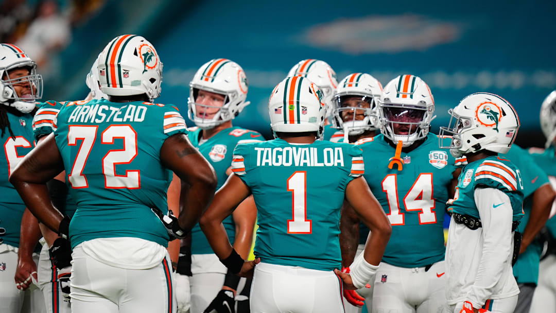 Miami Dolphins offensive tackle Terron Armstead (72) and Miami Dolphins quarterback Tua Tagovailoa (1) talk to teammates prior to a game against the Pittsburgh Steelers at Hard Rock Stadium in 2022.