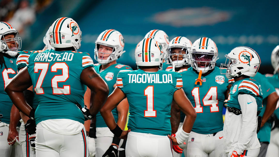 Miami Dolphins offensive tackle Terron Armstead (72) and Miami Dolphins quarterback Tua Tagovailoa (1) talk to teammates prior to a game against the Pittsburgh Steelers at Hard Rock Stadium in 2022.