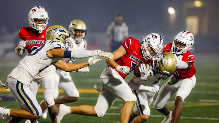 Chaminade Madonna wide receiver Jansen Lopez running against St. John Bosco’s defense 