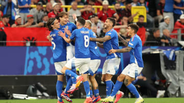 The Italian players celebrate the decisive goal scored by Nicolò Barella