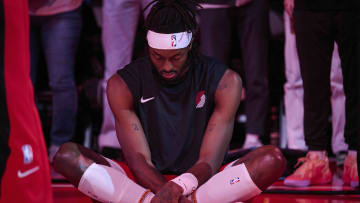 Dec 26, 2023; Portland, Oregon, USA; Portland Trail Blazers forward Jerami Grant (9) quietly sits on the court during introductions before a game against the Sacramento Kings at Moda Center. Mandatory Credit: Troy Wayrynen-USA TODAY Sports