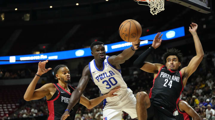 Jul 15, 2024; Las Vegas, NV, USA; Philadelphia 76ers forward/center Adem Bona (30) attempts to catch the rebound against Portland Trail Blazers forward Justin Minaya (24) and guard/forward Rayan Rupert during the second half at Thomas & Mack Center. Mandatory Credit: Lucas Peltier-USA TODAY Sports