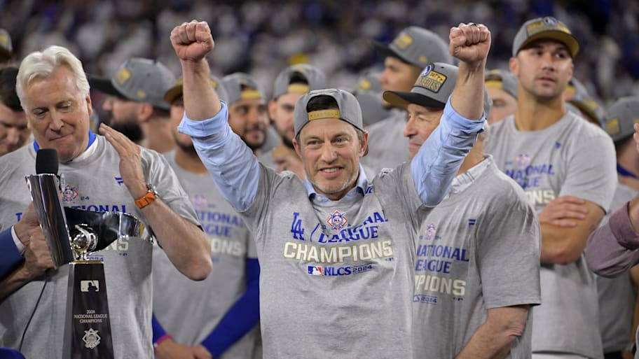 Los Angeles Dodgers president of baseball operations Andrew Friedman celebrates on the podium after winning 2024 NLCS
