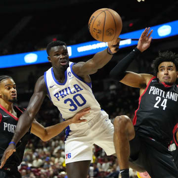 Jul 15, 2024; Las Vegas, NV, USA; Philadelphia 76ers forward/center Adem Bona (30) attempts to catch the rebound against Portland Trail Blazers forward Justin Minaya (24) and guard/forward Rayan Rupert during the second half at Thomas & Mack Center. Mandatory Credit: Lucas Peltier-USA TODAY Sports