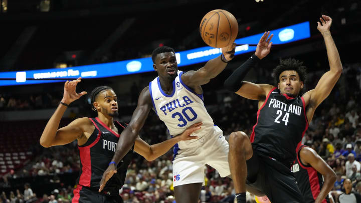 Jul 15, 2024; Las Vegas, NV, USA; Philadelphia 76ers forward/center Adem Bona (30) attempts to catch the rebound against Portland Trail Blazers forward Justin Minaya (24) and guard/forward Rayan Rupert during the second half at Thomas & Mack Center. Mandatory Credit: Lucas Peltier-USA TODAY Sports