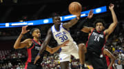 Jul 15, 2024; Las Vegas, NV, USA; Philadelphia 76ers forward/center Adem Bona (30) attempts to catch the rebound against Portland Trail Blazers forward Justin Minaya (24) and guard/forward Rayan Rupert during the second half at Thomas & Mack Center. Mandatory Credit: Lucas Peltier-USA TODAY Sports