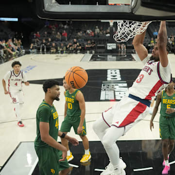 St. John's Red Storm forward Bryce Hopkins (23) dunks the ball against the Baylor Bears in a 2025 Players Era Festival group play game at Michelob Ultra Arena