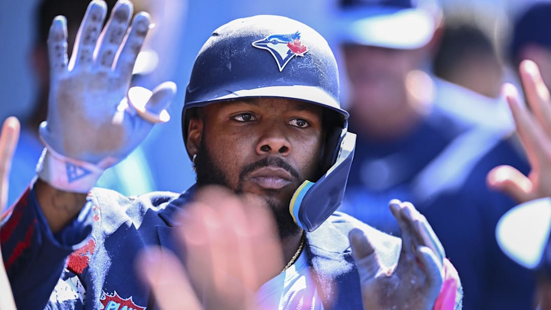 Aug 10, 2025; Los Angeles, California, USA; Toronto Blue Jays first baseman Vladimir Guerrero Jr. (27) celebrates with teammates after hitting a solo home run against the Los Angeles Dodgers during the eighth inning at Dodger Stadium. Mandatory Credit: Jonathan Hui-Imagn Images