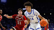 Nov 4, 2025; Lexington, Kentucky, USA; Kentucky Wildcats center Malachi Moreno (24) drives to the basket around Nicholls Colonels guard Nick Krass (21) during the second half at Rupp Arena at Central Bank Center. Mandatory Credit: Jordan Prather-Imagn Images