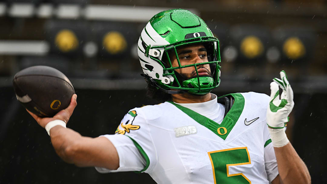 Nov 8, 2025; Iowa City, Iowa, USA; Oregon Ducks quarterback Dante Moore (5) warms up before the game against the Iowa Hawkeyes at Kinnick Stadium. Mandatory Credit: Jeffrey Becker-Imagn Images
