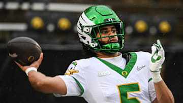 Nov 8, 2025; Iowa City, Iowa, USA; Oregon Ducks quarterback Dante Moore (5) warms up before the game against the Iowa Hawkeyes at Kinnick Stadium. Mandatory Credit: Jeffrey Becker-Imagn Images