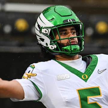 Nov 8, 2025; Iowa City, Iowa, USA; Oregon Ducks quarterback Dante Moore (5) warms up before the game against the Iowa Hawkeyes at Kinnick Stadium. Mandatory Credit: Jeffrey Becker-Imagn Images