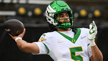Nov 8, 2025; Iowa City, Iowa, USA; Oregon Ducks quarterback Dante Moore (5) warms up before the game against the Iowa Hawkeyes at Kinnick Stadium. Mandatory Credit: Jeffrey Becker-Imagn Images