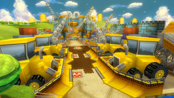 A factory with a racetrack going through it. There are diggers and craned on either side in Mario Kart Wii.