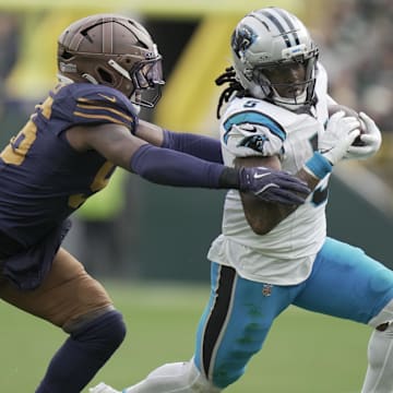Nov 2, 2025; Green Bay, Wisconsin, USA;  Green Bay Packers' Edgerrin Cooper (56) pursues Carolina Panthers running back Rico Dowdle (5) during the third quarter of their game at Lambeau Field. Mandatory Credit: Mark Hoffman-USA TODAY Network via Imagn Images
