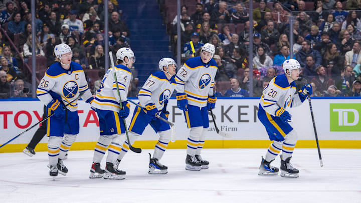 Jan 21, 2025; Vancouver, British Columbia, CAN; Buffalo Sabres defenseman Rasmus Dahlin (26) and defenseman Bowen Byram (4) and forward JJ Peterka (77) and forward Tage Thompson (72) and forward Jiri Kulich (20) celebrate Kulich’s goal against the Vancouver Canucks in the third period at Rogers Arena. Mandatory Credit: Bob Frid-Imagn Images