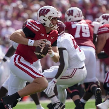 Sep 14, 2024; Madison, Wisconsin, USA;  Wisconsin Badgers quarterback Tyler Van Dyke (10) scrambles with the football during the first quarter against the Alabama Crimson Tide at Camp Randall Stadium. Mandatory Credit: Jeff Hanisch-Imagn Images