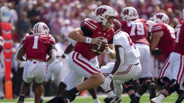 Sep 14, 2024; Madison, Wisconsin, USA;  Wisconsin Badgers quarterback Tyler Van Dyke (10) scrambles with the football during the first quarter against the Alabama Crimson Tide at Camp Randall Stadium. Mandatory Credit: Jeff Hanisch-Imagn Images