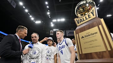 Mar 9, 2025; St. Louis, Missouri, USA;  Drake Bulldogs head coach Ben McCollum and guard Bennett Stirtz (14) are interviewed after defeating the Bradley Braves to win the Missouri Valley Conference Tournament Championship at Enterprise Center. Mandatory Credit: Jeff Curry-Imagn Images
