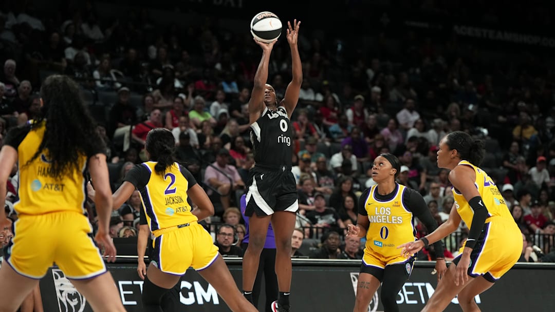 Jun 11, 2025; Las Vegas, Nevada, USA; Las Vegas Aces guard Jackie Young (0) shoots the ball against the Los Angeles Sparks during the first half of a WNBA basketball game at Michelob Ultra Arena. 