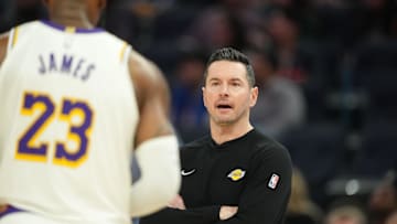 Jan 25, 2025; San Francisco, California, USA; Los Angeles Lakers head coach JJ Redick (center) talks with forward LeBron James (23) during the third quarter against the Golden State Warriors at Chase Center. Mandatory Credit: Darren Yamashita-Imagn Images