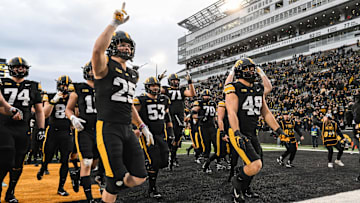 Oct 25, 2025; Iowa City, Iowa, USA; Iowa Hawkeyes linebacker Kelby Telander (25) and defensive lineman Ethan Hurkett (49) and the rest of the team react after the game against the Minnesota Golden Gophers at Kinnick Stadium. Mandatory Credit: Jeffrey Becker-Imagn Images